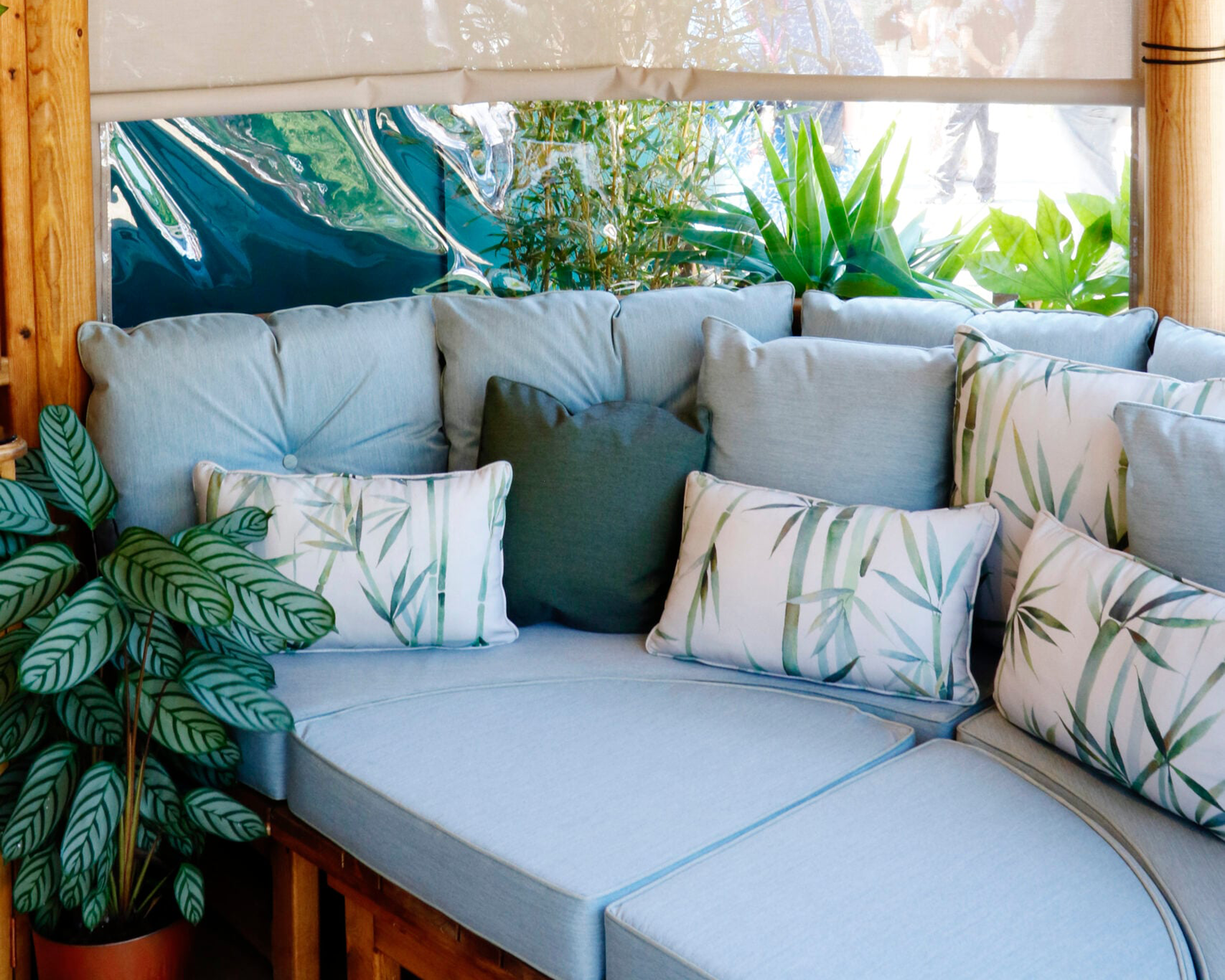 Day bed in an Oval Breeze House with light blue cushions